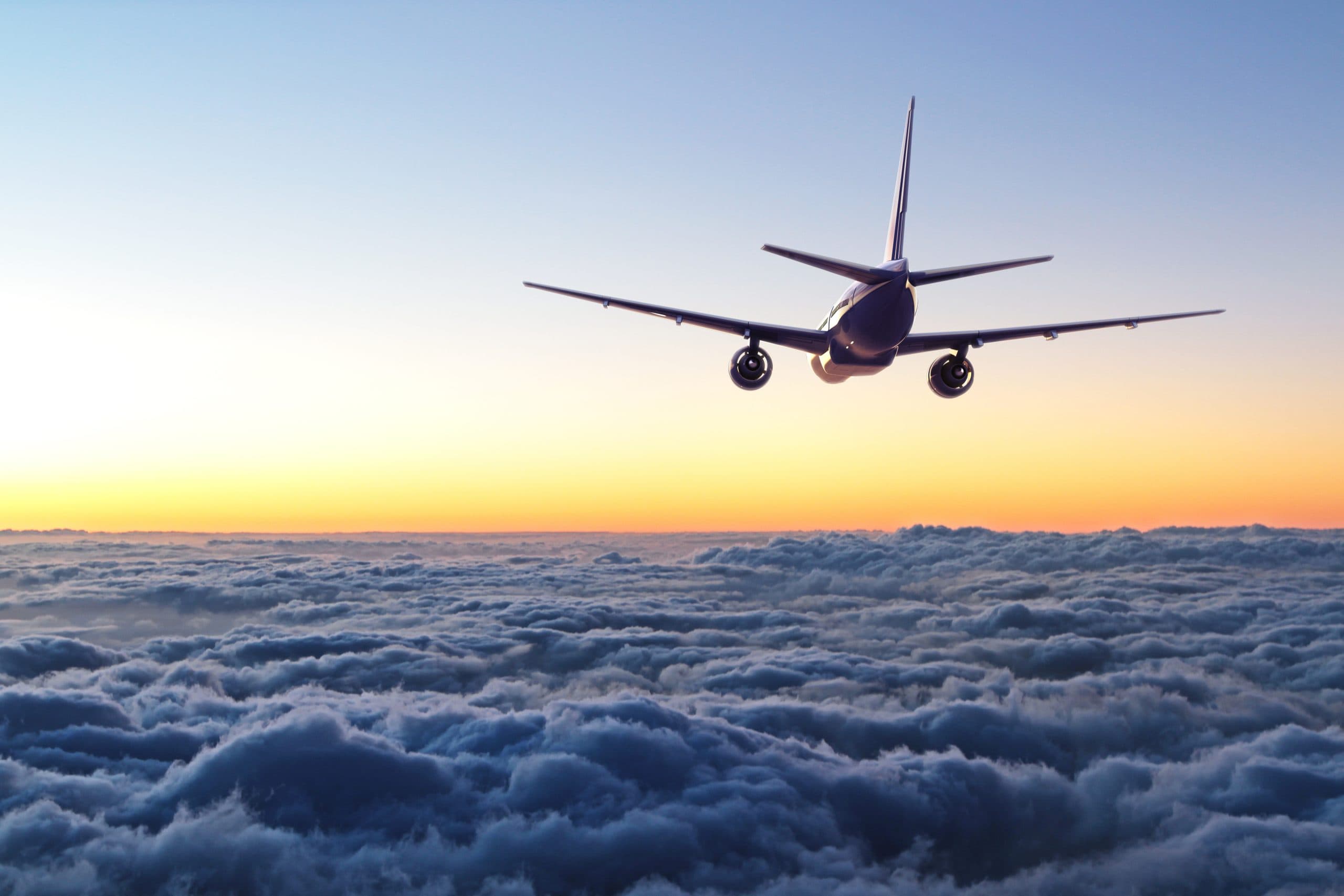 An airliner above the clouds at sunset