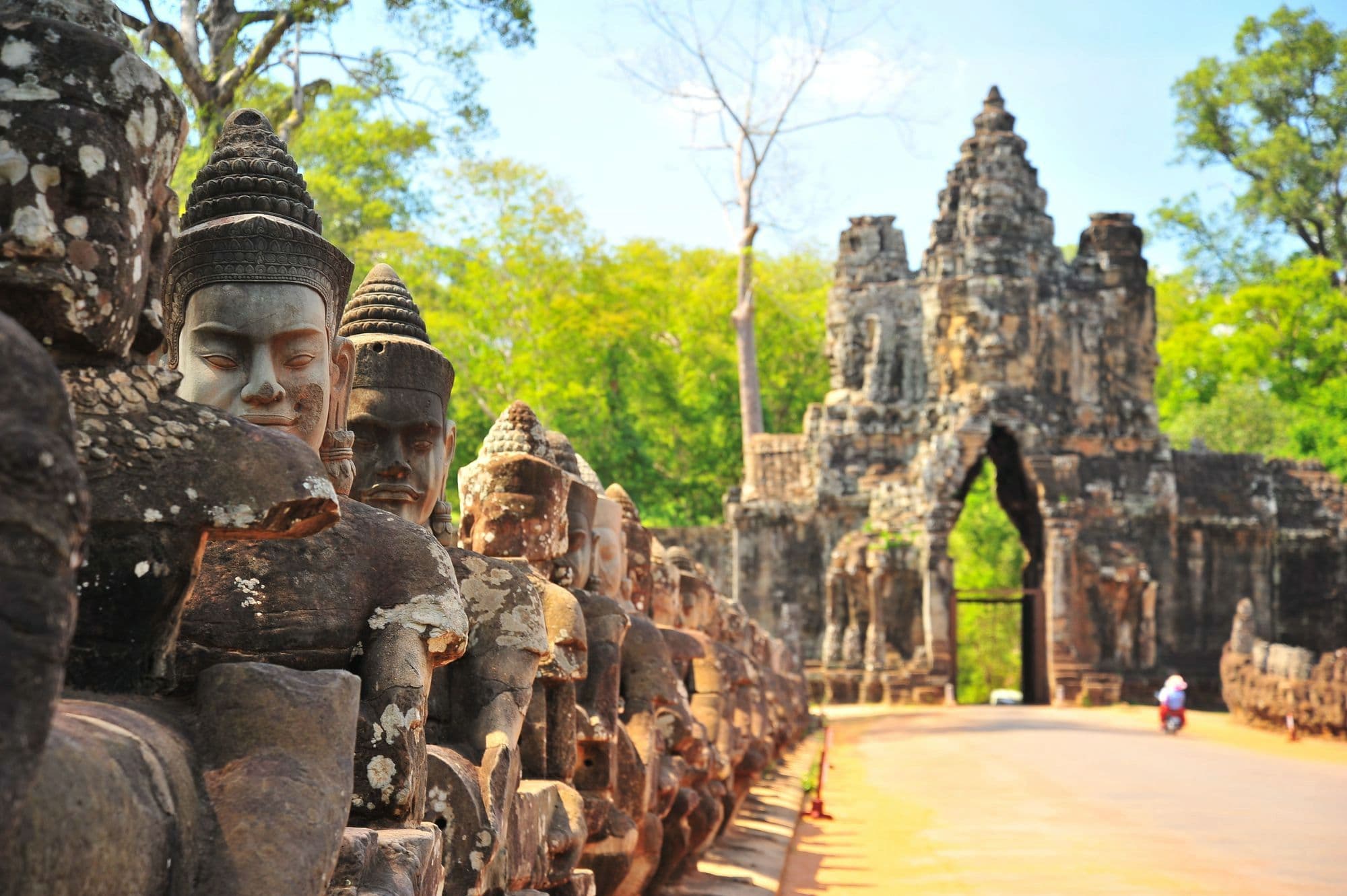 Stone guardians lining the causeway to an Angkor gate